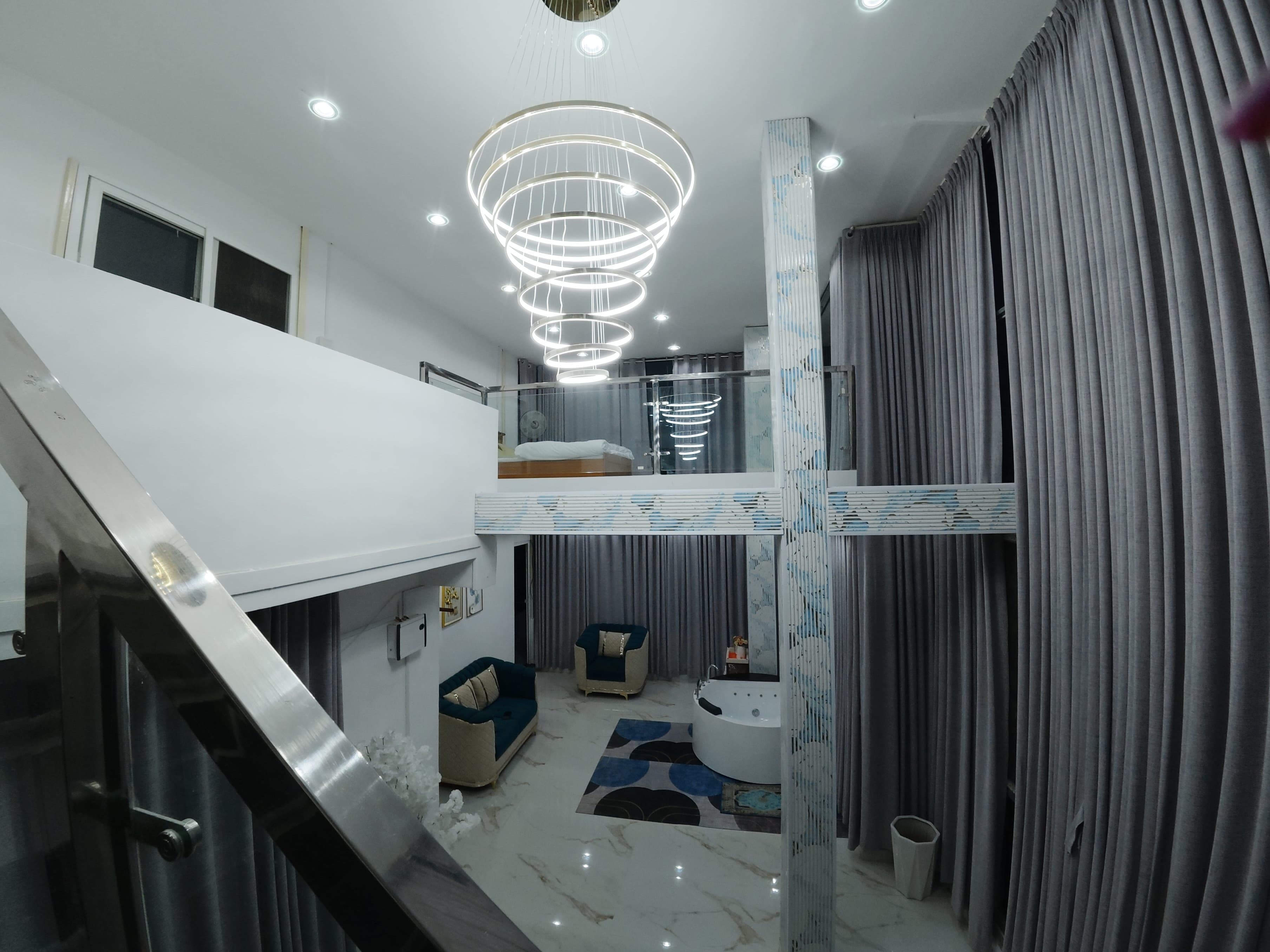 Dream Mansion - Grand interior atrium with cascading spiral chandelier, indoor jacuzzi lounge, and mezzanine suite