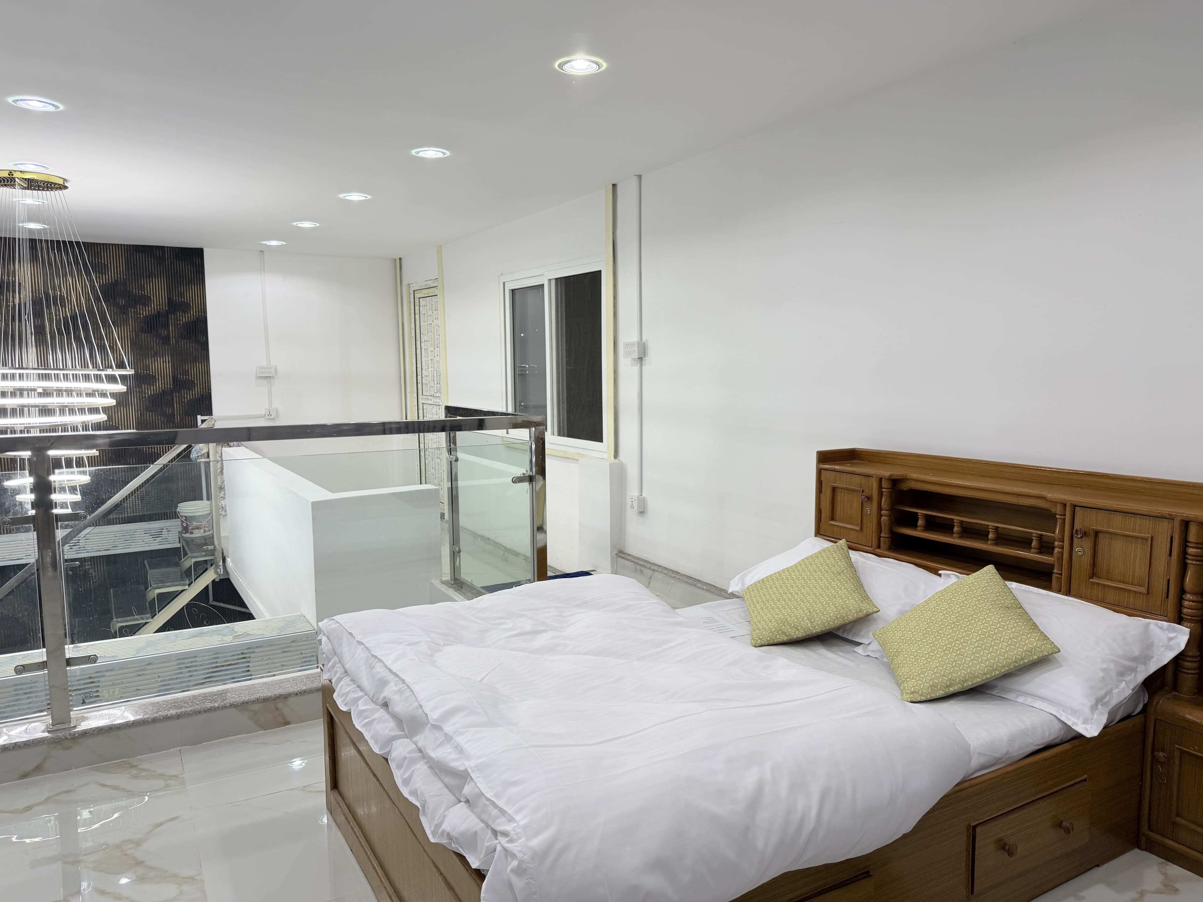 Mezzanine suite bedside detail and architectural glass balustrade