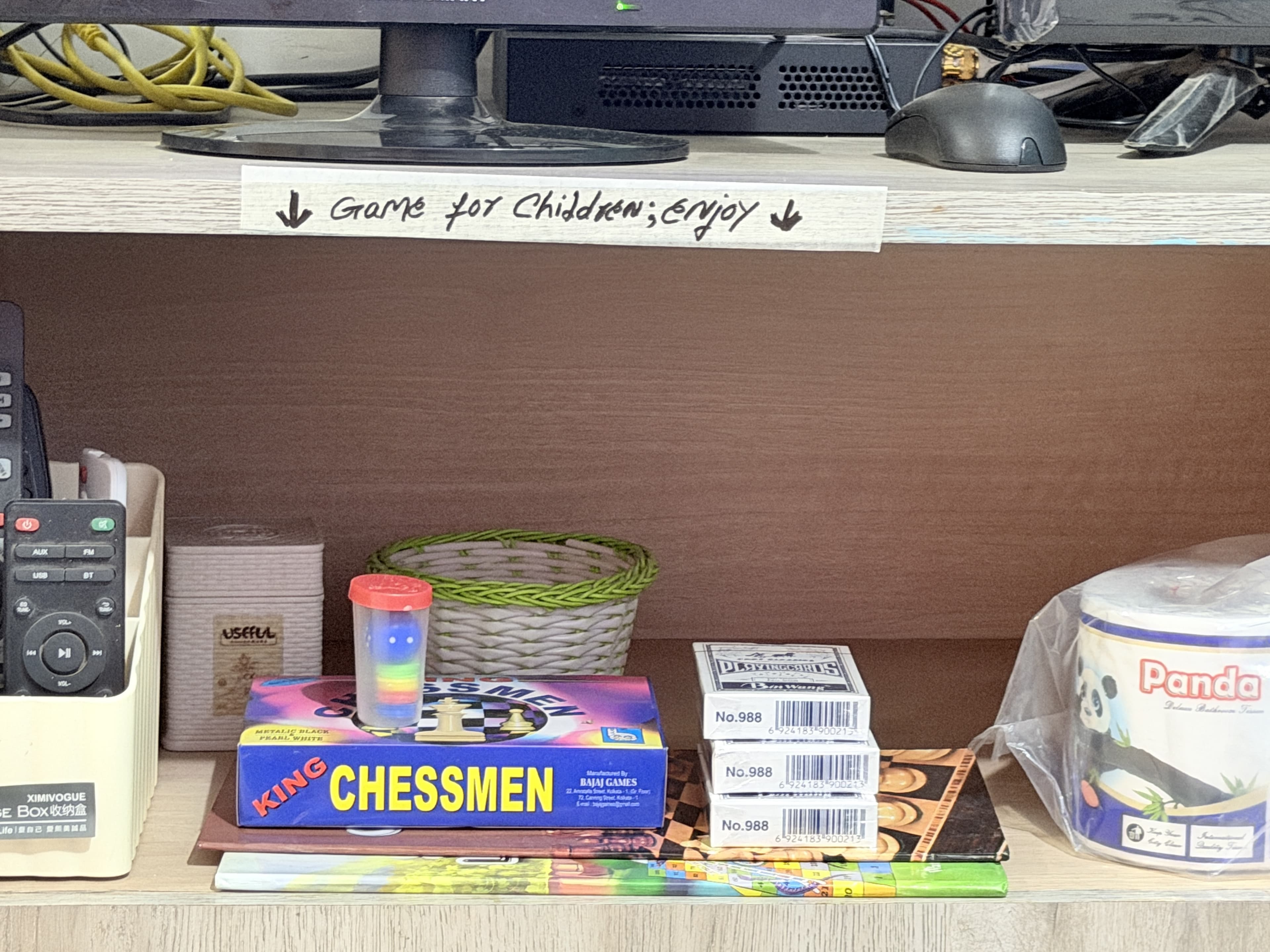 Leisure and entertainment shelf with chess set, board games, and books