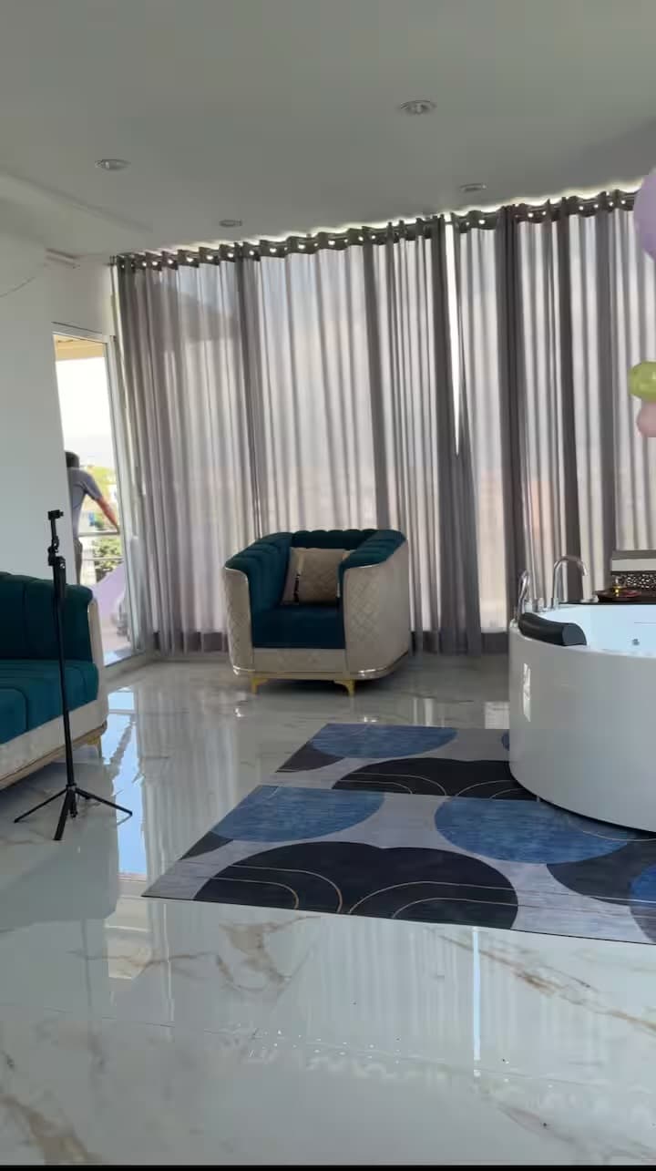 Dream Mansion lounge area adjoining the jacuzzi with marble floors and designer armchair