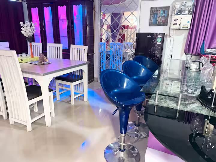 Dining room and kitchen with bar counter and modern blue swivel stools